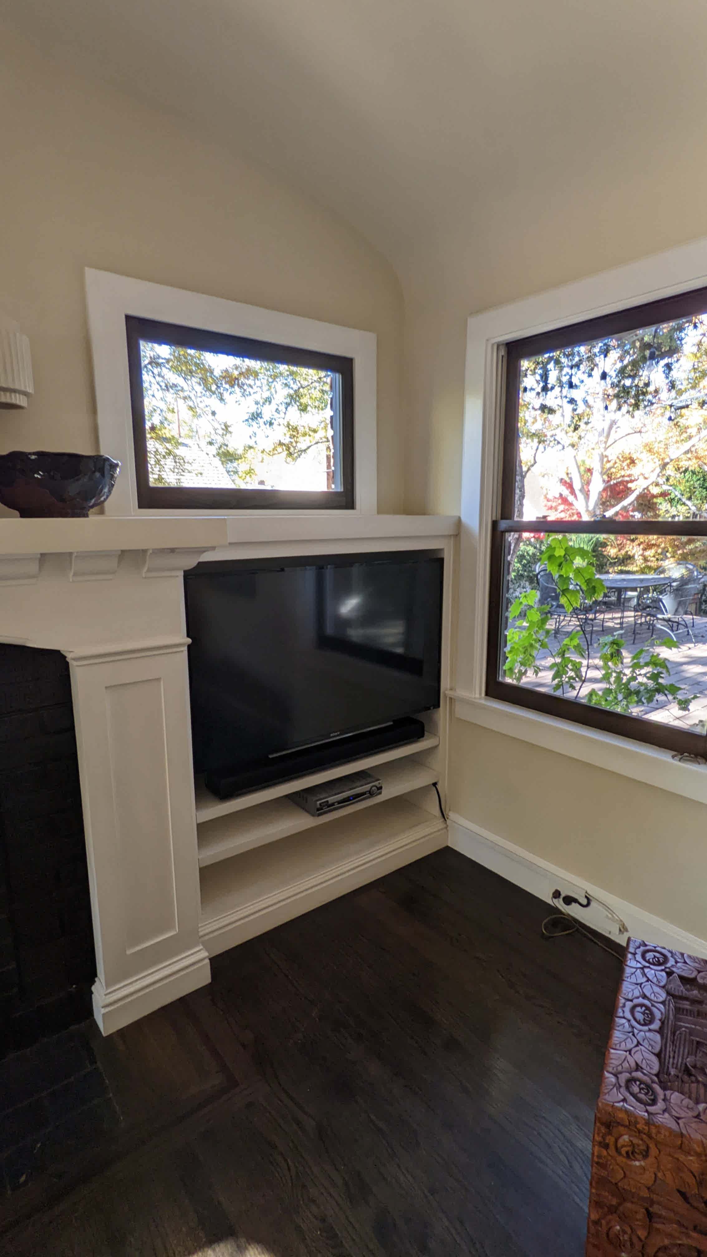 TV in built-in niche next to fireplace in Sacramento, CA
