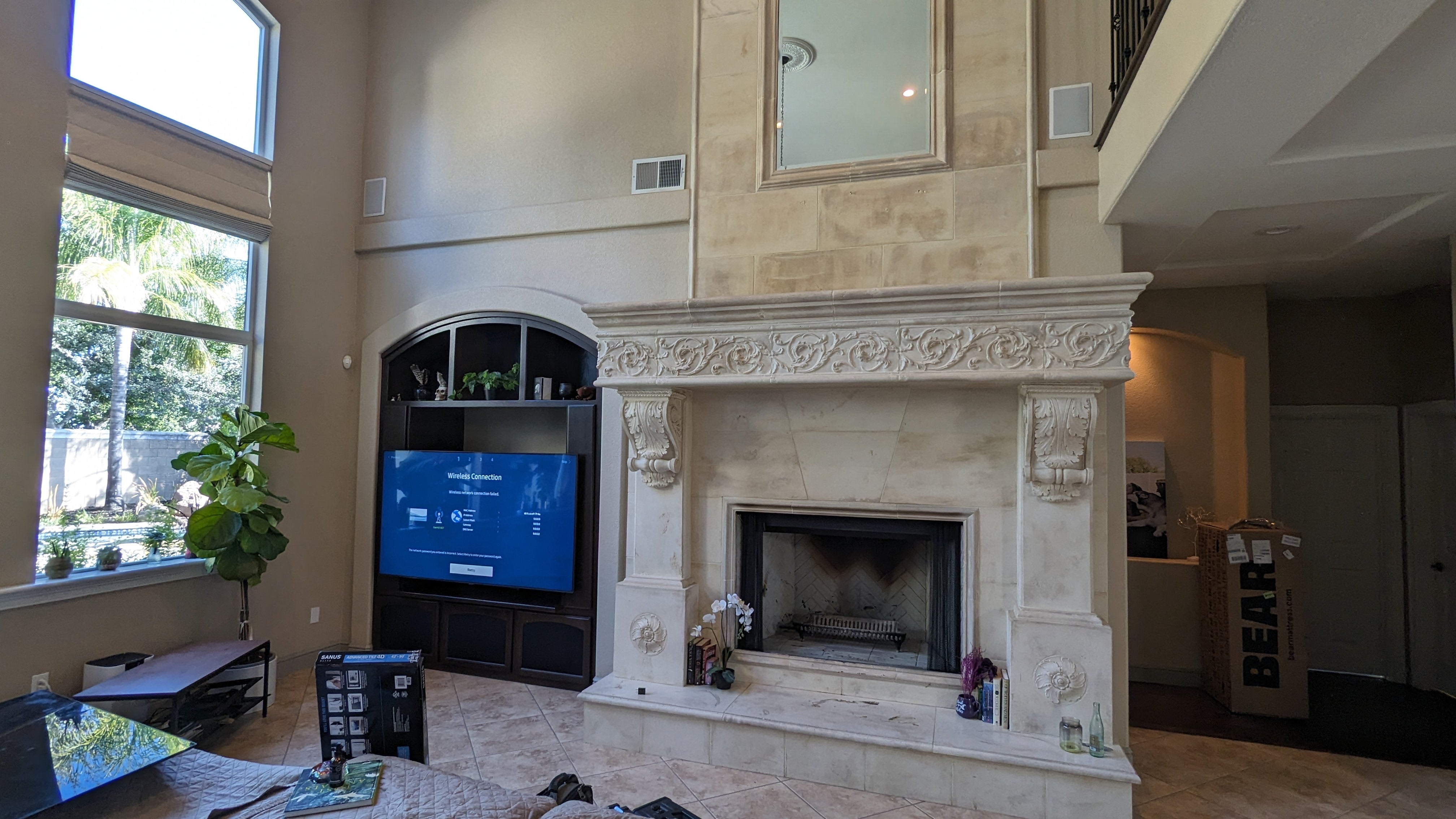 TV in arched built-in next to stone fireplace in Rocklin, CA